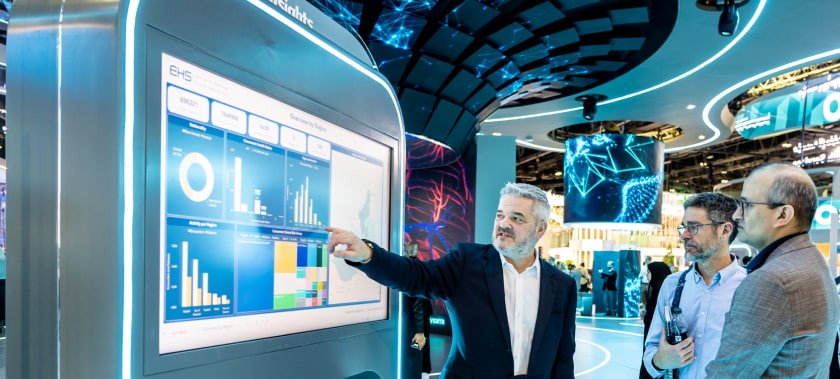 WHX attendees looking at screen with graphs