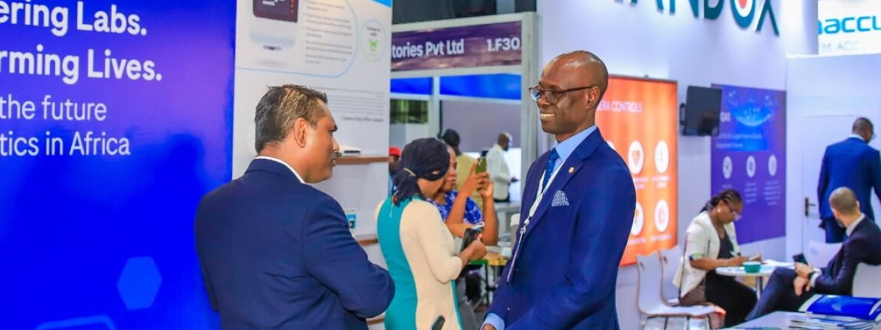 Delegates talking at a stand at WHX Labs Lagos